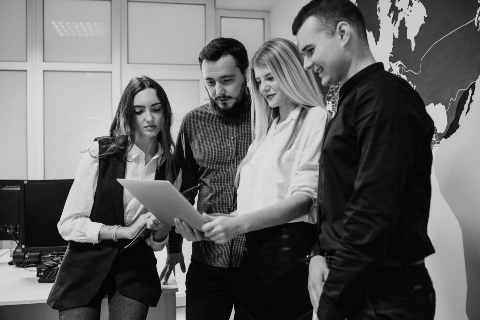 Small business owner working on budget calculations with calculator and financial reports